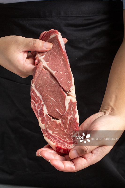 手拿着眼肉牛排图片素材