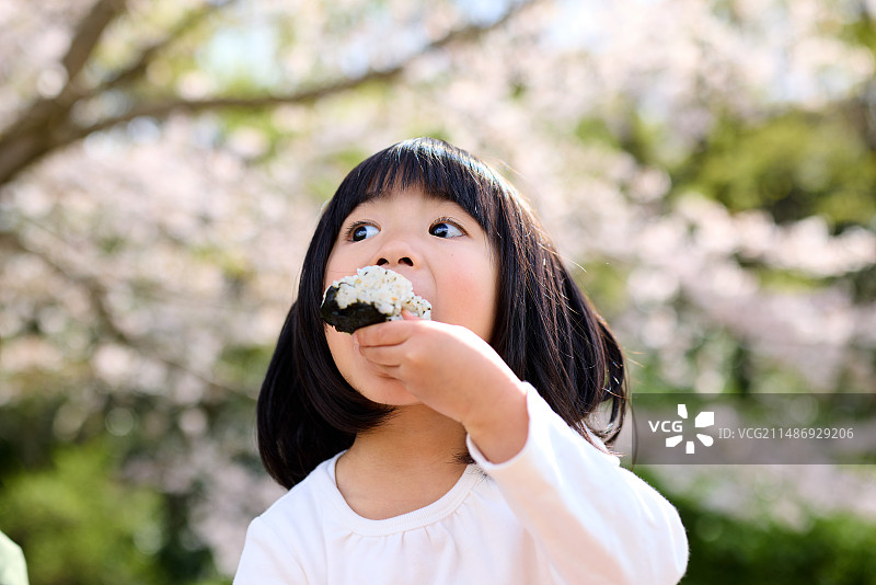 小女孩正在吃饭团图片素材