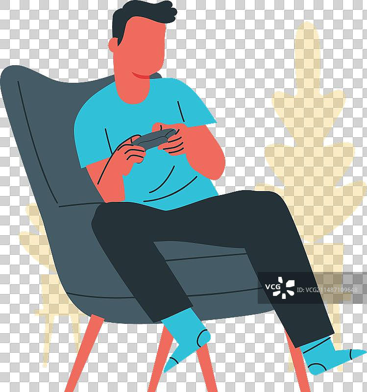 坐在扶手椅上玩游戏的年轻男人图片素材