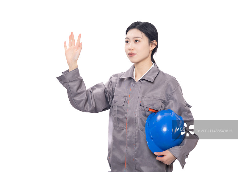穿着工人服装手持安全帽做手势的年轻女性图片素材
