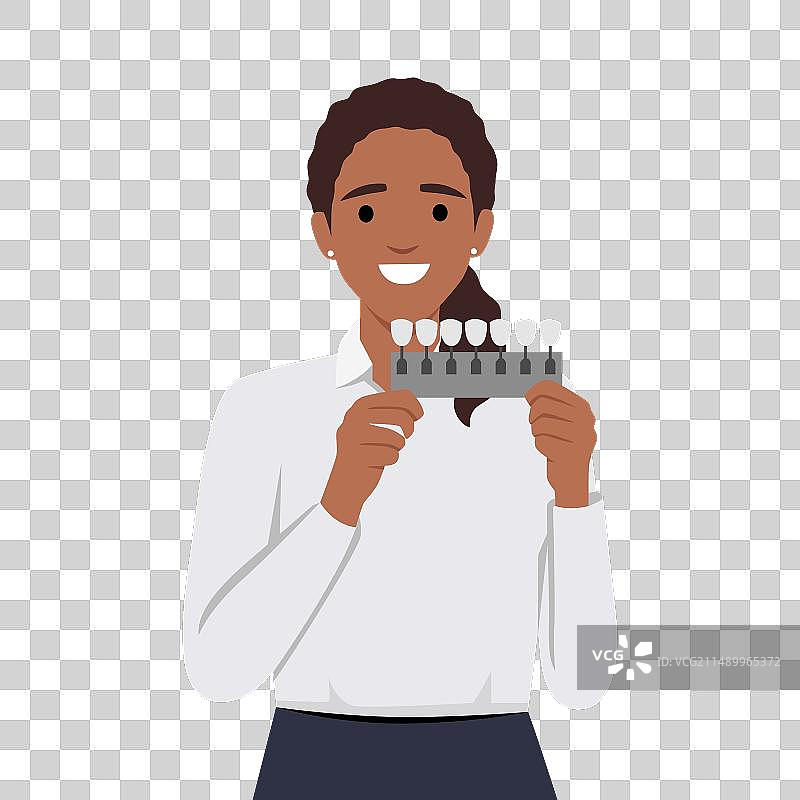 女人拿着牙齿颜色比色板图片素材