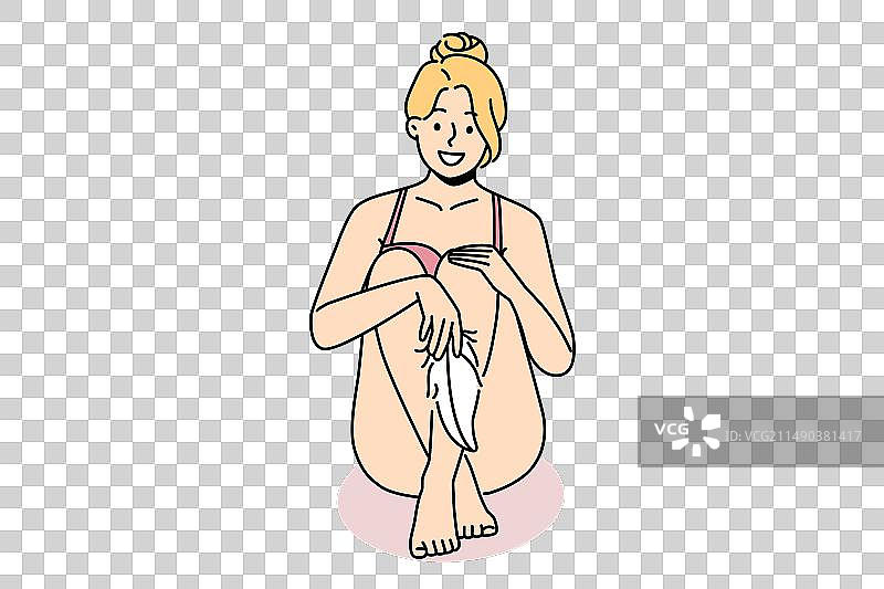 女人用柔软的羽毛触摸腿图片素材
