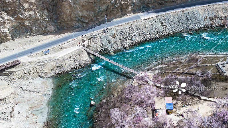 蓝色的河流穿过新疆杏花村 公路边鲜花盛开图片素材