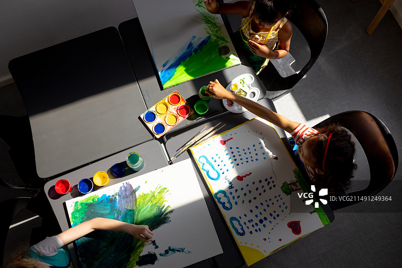 学校美术课上，混血女孩和白人女孩一起绘画图片素材
