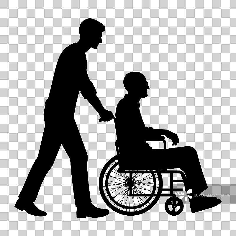 推着轮椅的年轻男人轮廓图片素材