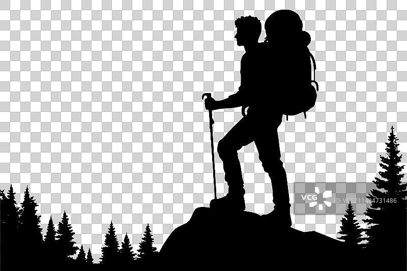 背包徒步旅行者在山顶的剪影图片素材