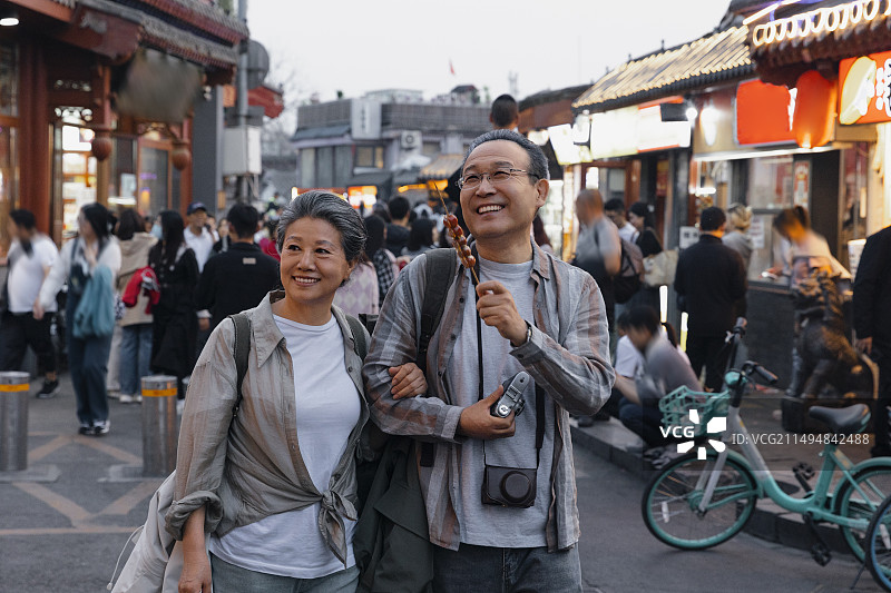 老年人City walk系列:老年夫妇在北京什刹海胡同商业街旅行图片素材