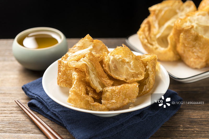 一盘油炸面筋摆放在桌面上特写图片素材