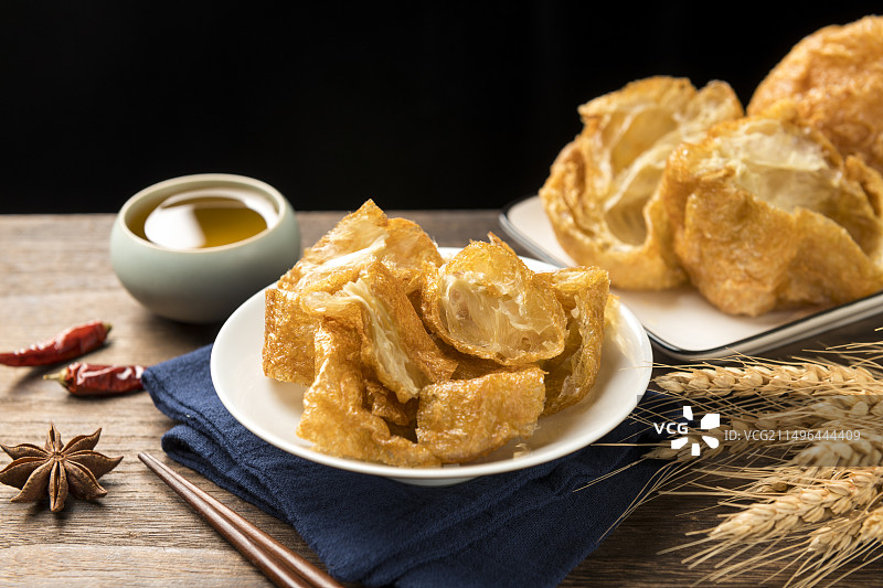 一盘油炸面筋摆放在桌面上特写图片素材