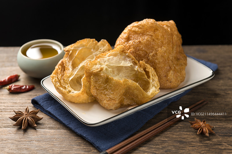 一盘油炸面筋摆放在桌面上特写图片素材