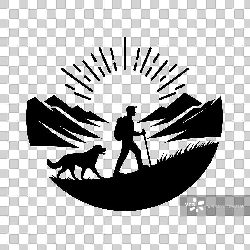 徒步旅行者和他们的狗一起徒步的剪影图片素材