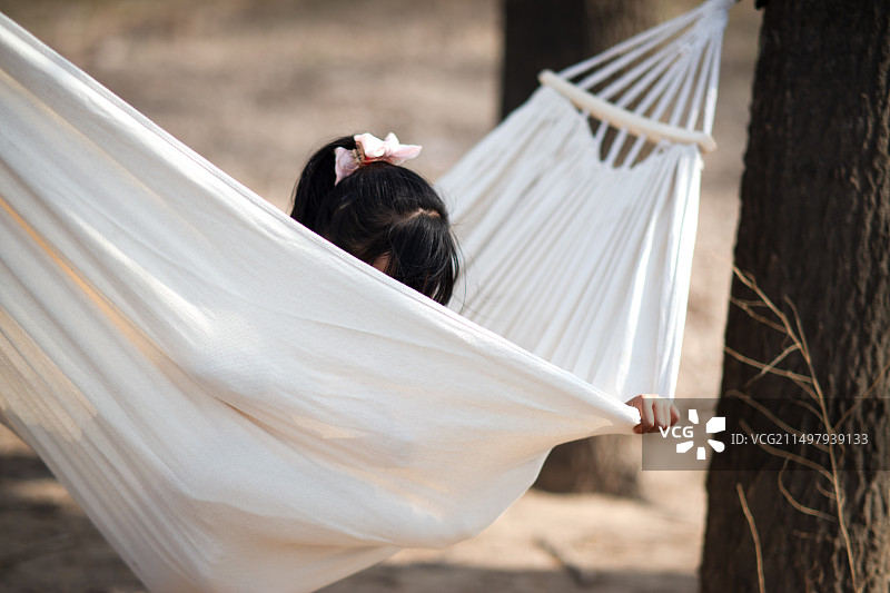 小女孩户外吊床玩耍图片素材