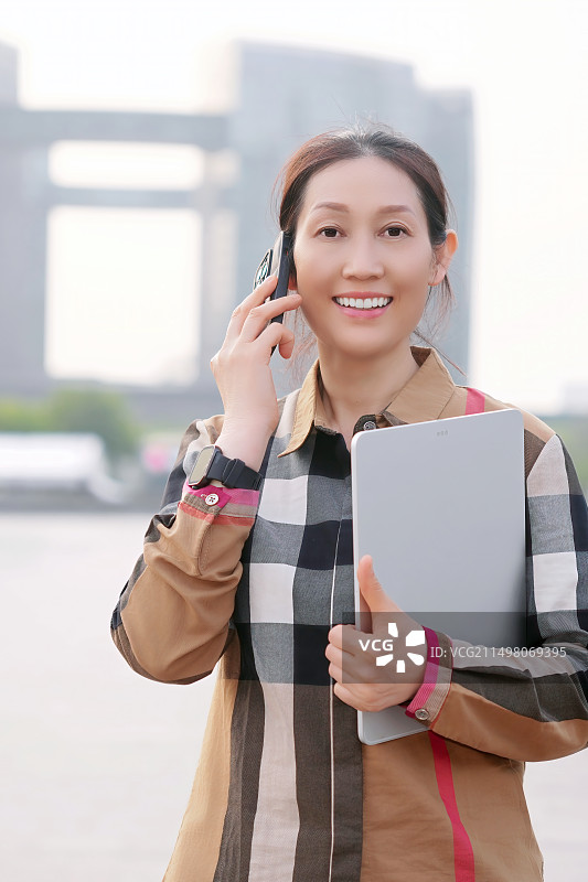 职业女性带着笔记本电脑外出图片素材