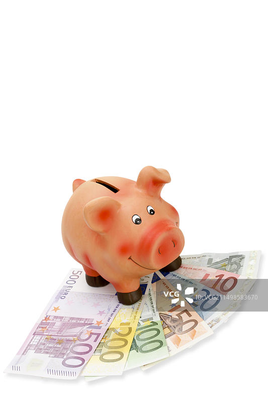 扇形展开的钞票上的存钱罐图片素材