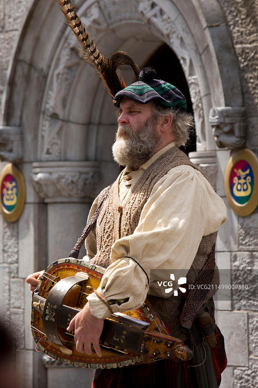 爱尔兰戈尔韦郡戈尔韦商店街的传统音乐家保罗·凯利在吟唱蜂酒吧演奏手摇风琴图片素材