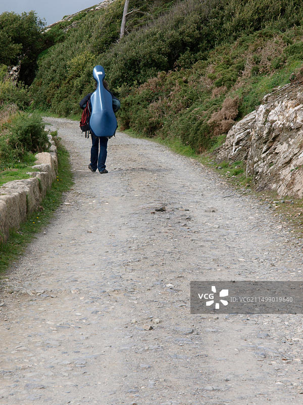 在英国康沃尔背着乐器行走的音乐家图片素材