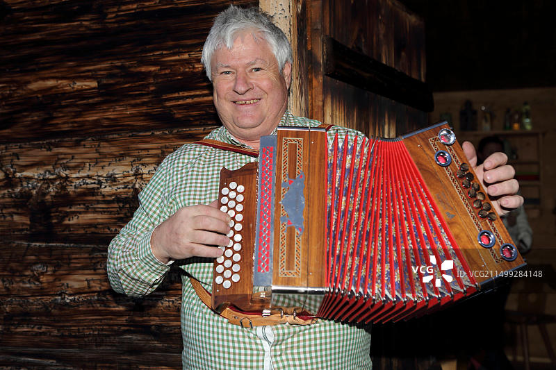 克莱门斯·瓦尔奇在奥地利莱希上方的木屋里演奏手风琴图片素材