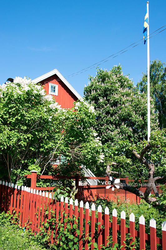 斯德哥尔摩附近瓦克斯霍尔姆岛上的传统红色木屋与花园图片素材
