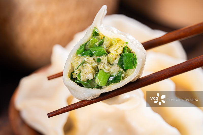 筷子夹起韭菜鸡蛋水饺图片素材