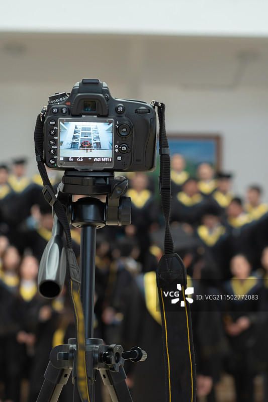 一台相机在给大学毕业生拍毕业照图片素材