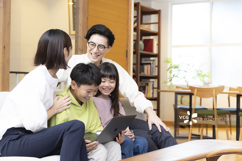 四口之家看笔记本电脑图片素材