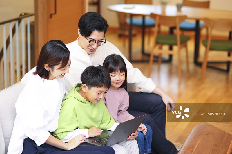 四口之家看笔记本电脑图片素材