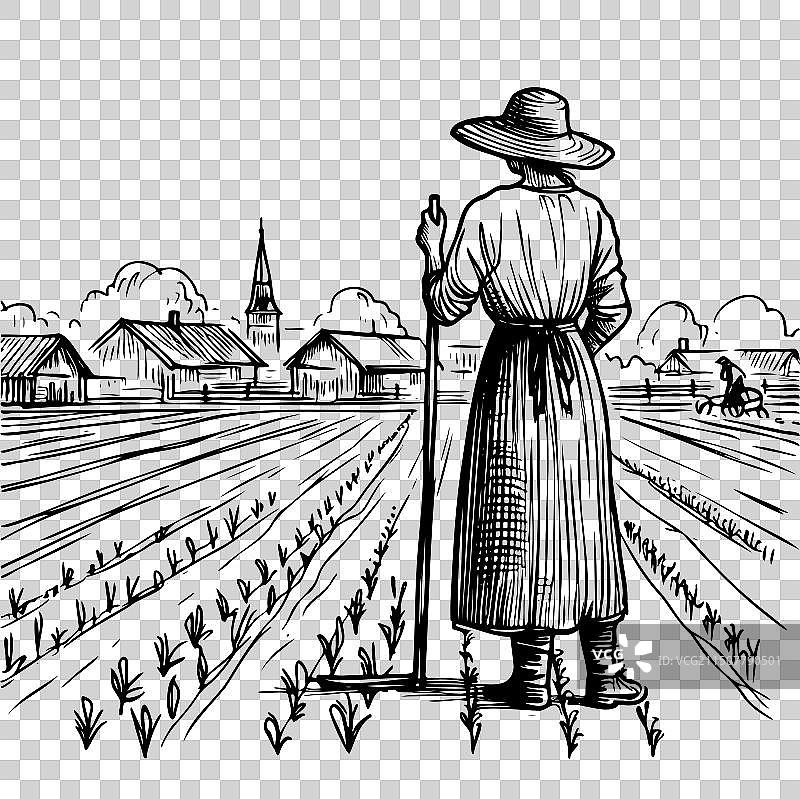 女子站在田野里，手持干草叉图片素材