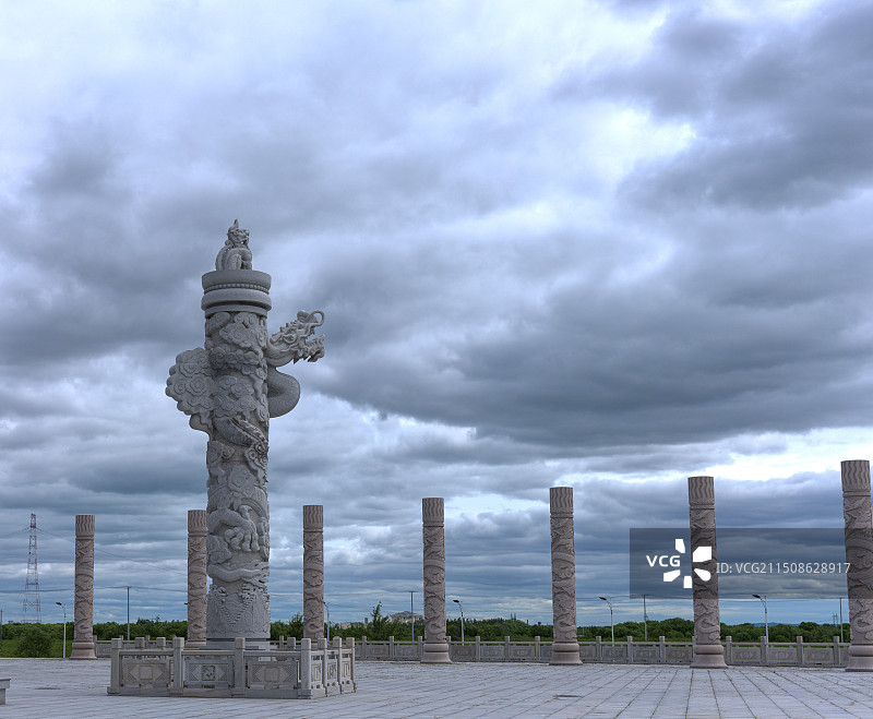 多云天空下的建筑景观：广场上的华表图片素材