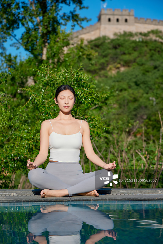 在长城脚下做瑜伽练习的女人图片素材