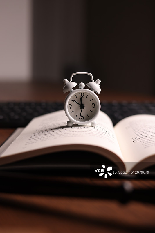 桌上有书的闹钟特写镜头图片素材