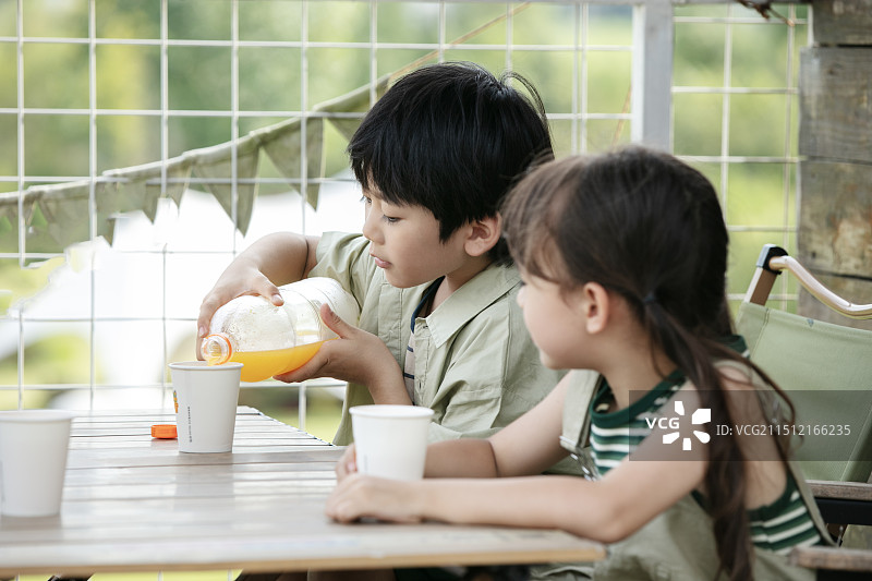 坐在小木屋外的小朋友图片素材