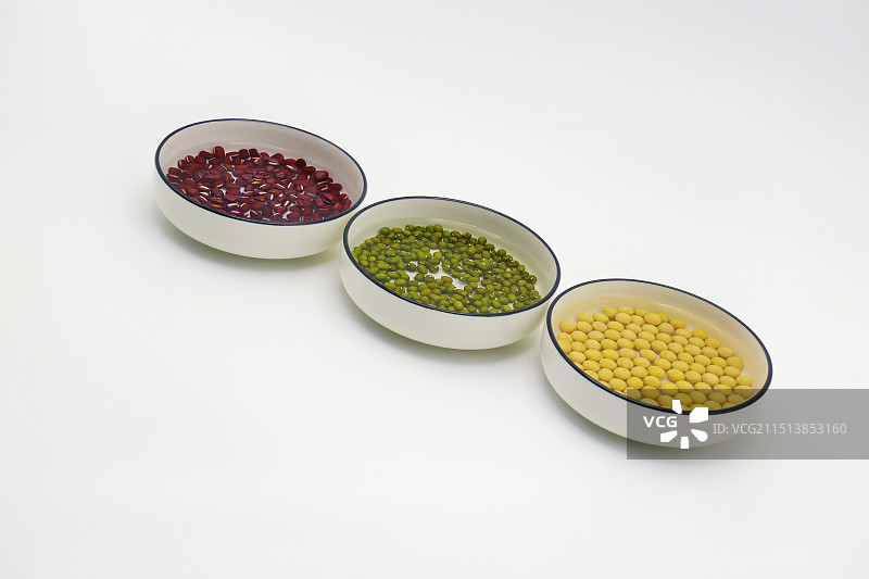 白色背景下泡水的五谷杂粮，泡水的绿豆，黄豆，红豆的特写镜头，杂粮组合，用来做五谷杂粮豆浆的原料图片素材