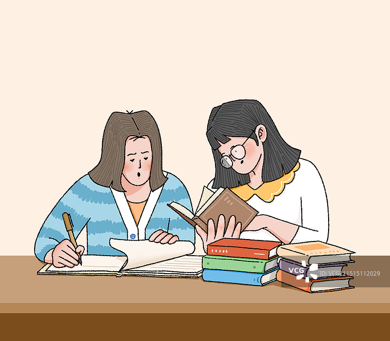两个女生在翻阅资料讨论学习中图片素材