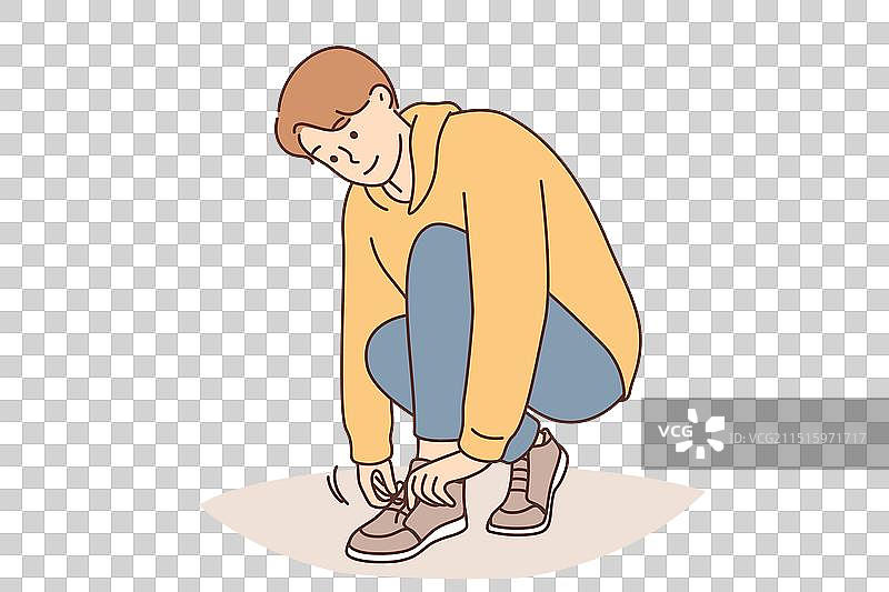 一个小男孩系鞋带图片素材