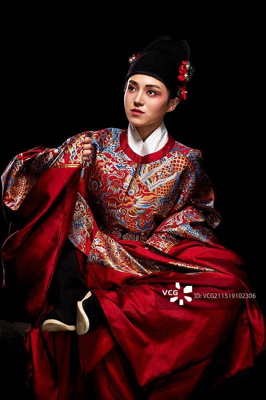 黑色背景下身着明代飞鱼服的青年女性图片素材