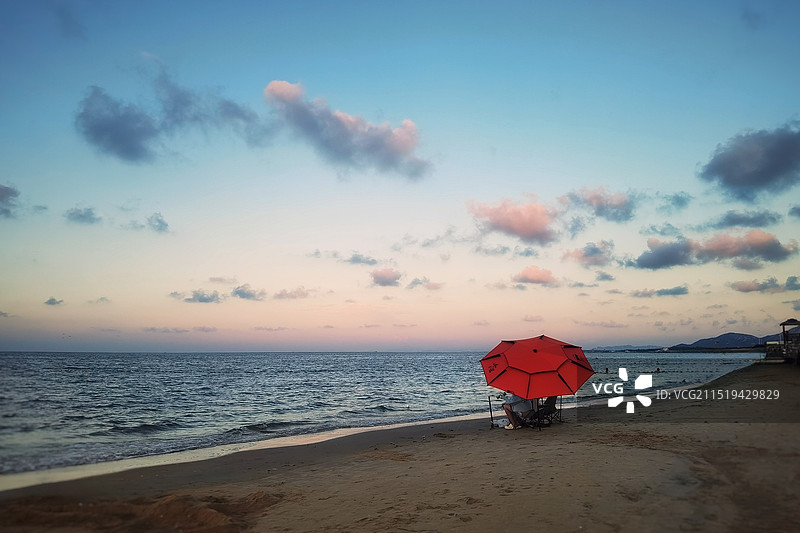 晚霞中海滩上的悠闲惬意图片素材