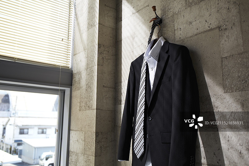 挂在墙上衣架上的西装和领带图片素材