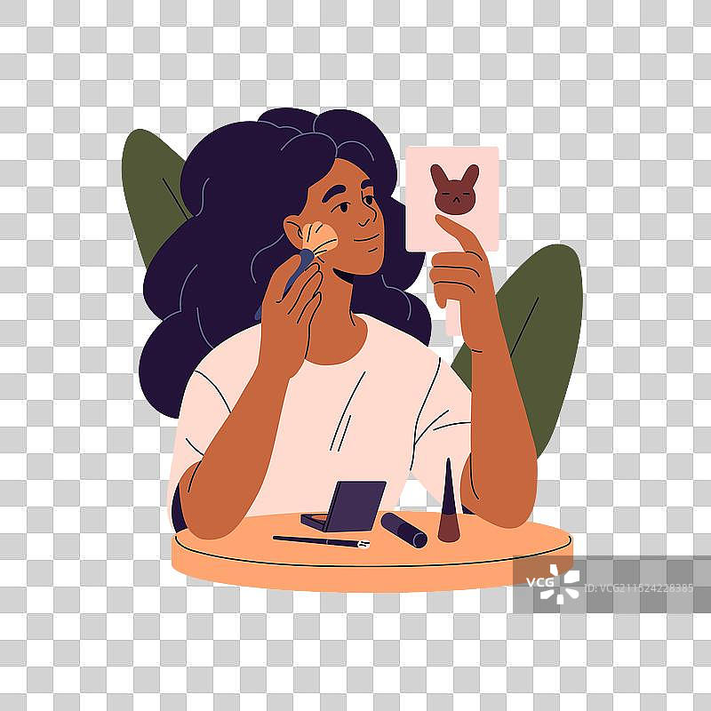 女孩在镜子前用粉饼化妆图片素材