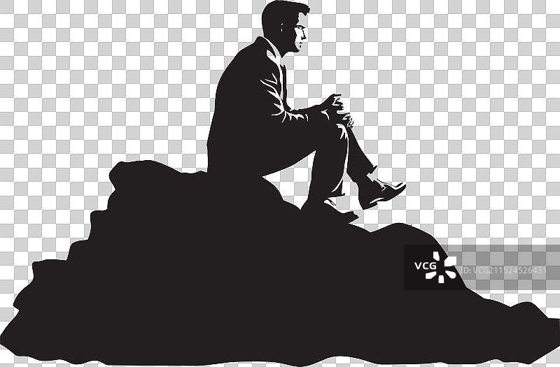 山岩上的静坐人物图片素材