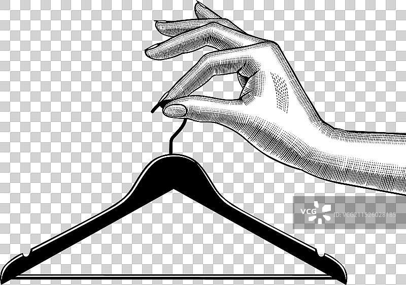 女人手握着衣架图片素材