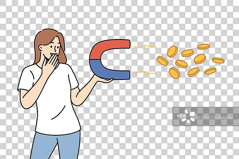 女人用磁铁吸引金钱并微笑图片素材