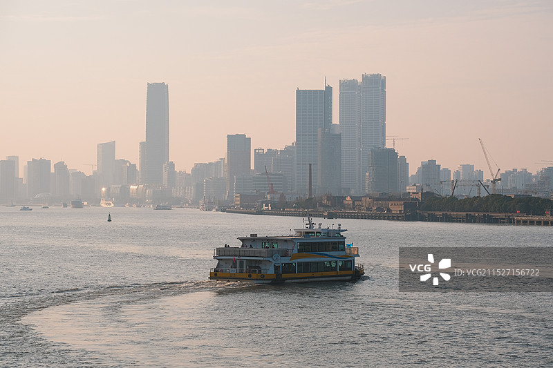 日落时的黄浦江越江渡轮和建筑物对天景观图片素材