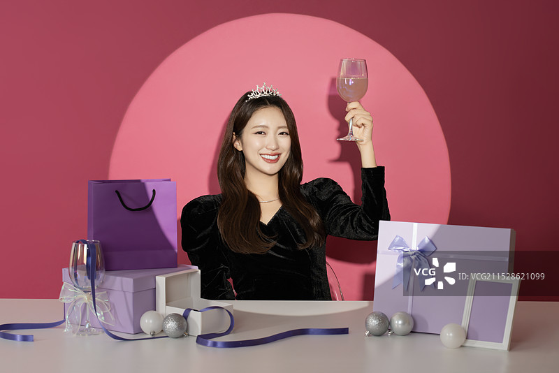 一位20多岁的女性主角在各种礼物面前受到关注和瞩目。图片素材