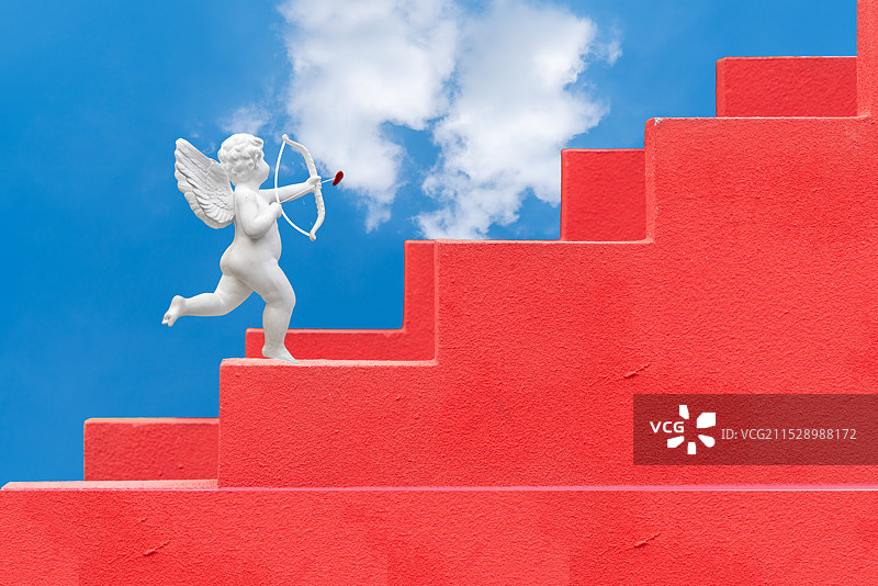 石膏像，爱神丘比特，红色砂岩粉刷的台阶图片素材