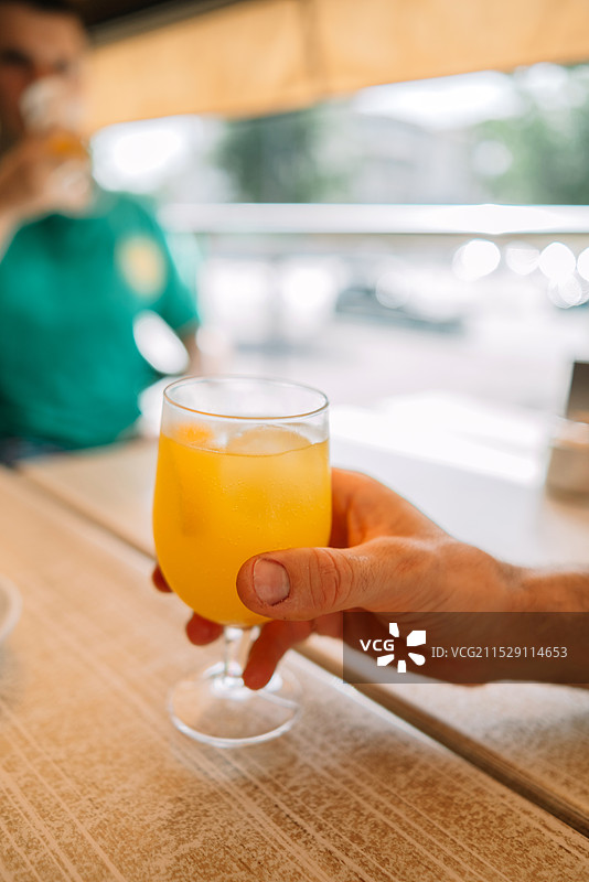 男人手握玻璃杯饮料的特写图片素材