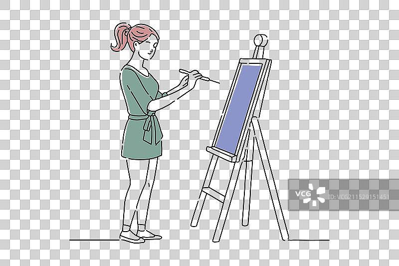 年轻女性在工作室用画笔绘画涂鸦图片素材