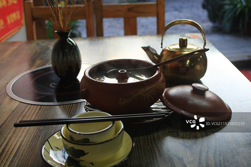 饮食店里桌子上的砂锅杯碗和茶壶的高角度视图图片素材