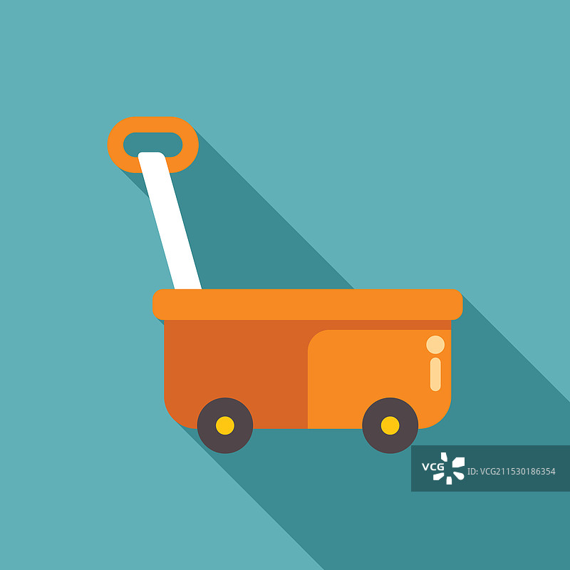 橙色玩具手推车在青绿色背景上投下长长的阴影图片素材