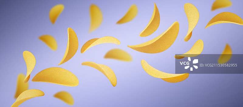 蓝色背景上飞舞的脆薯片图片素材