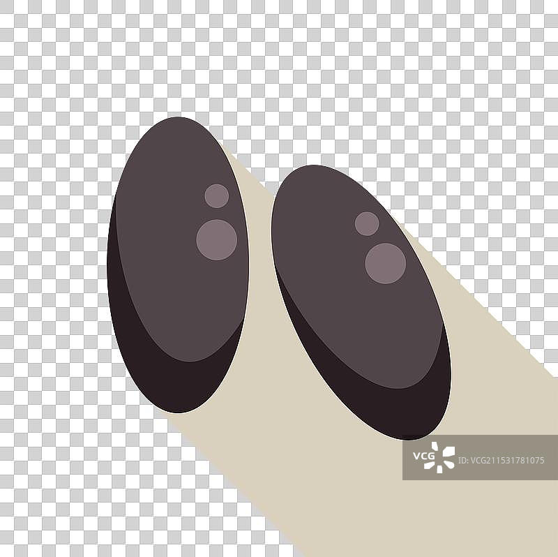 两颗黑豆在奶油色背景上投下长长的阴影图片素材